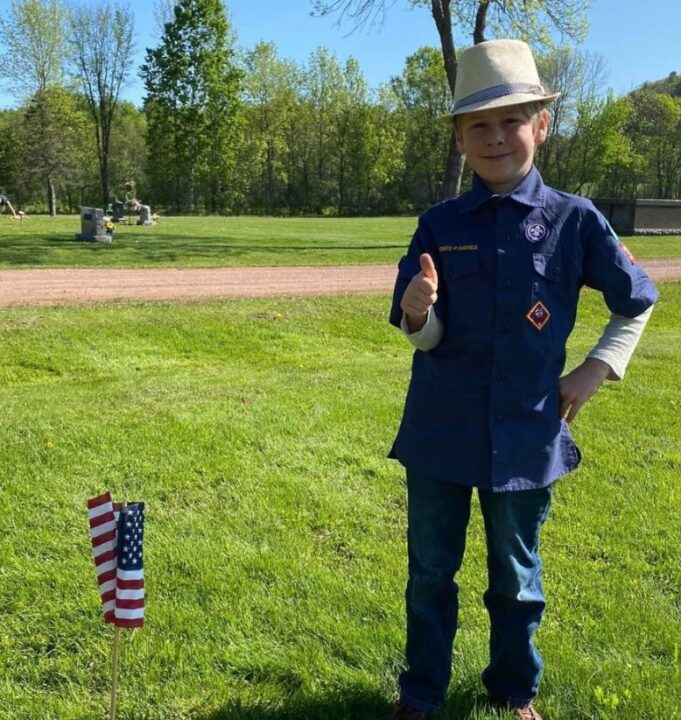 Cub Scout Placing flags on graves for Memorial Day, VAC, Voyageurs Area Council